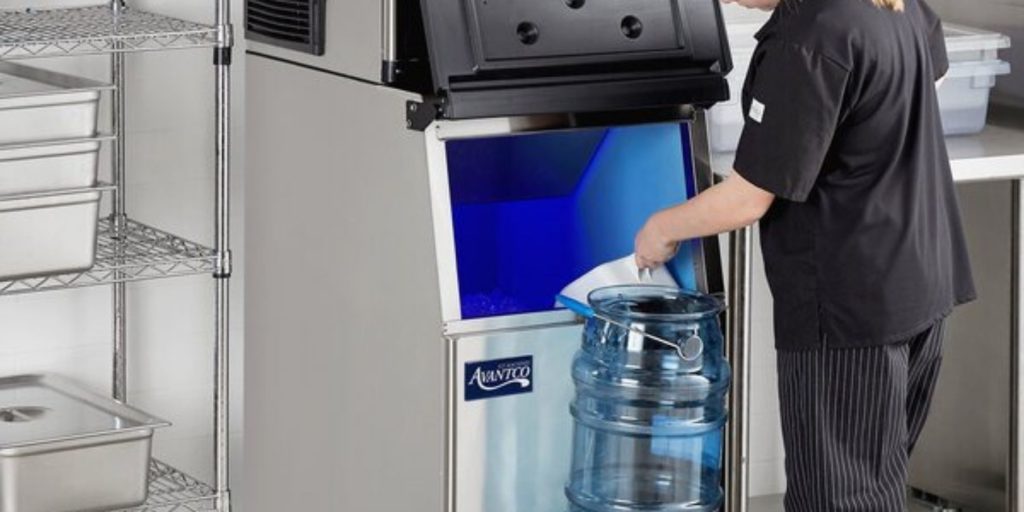 Woman collecting ice from a modular ice machine